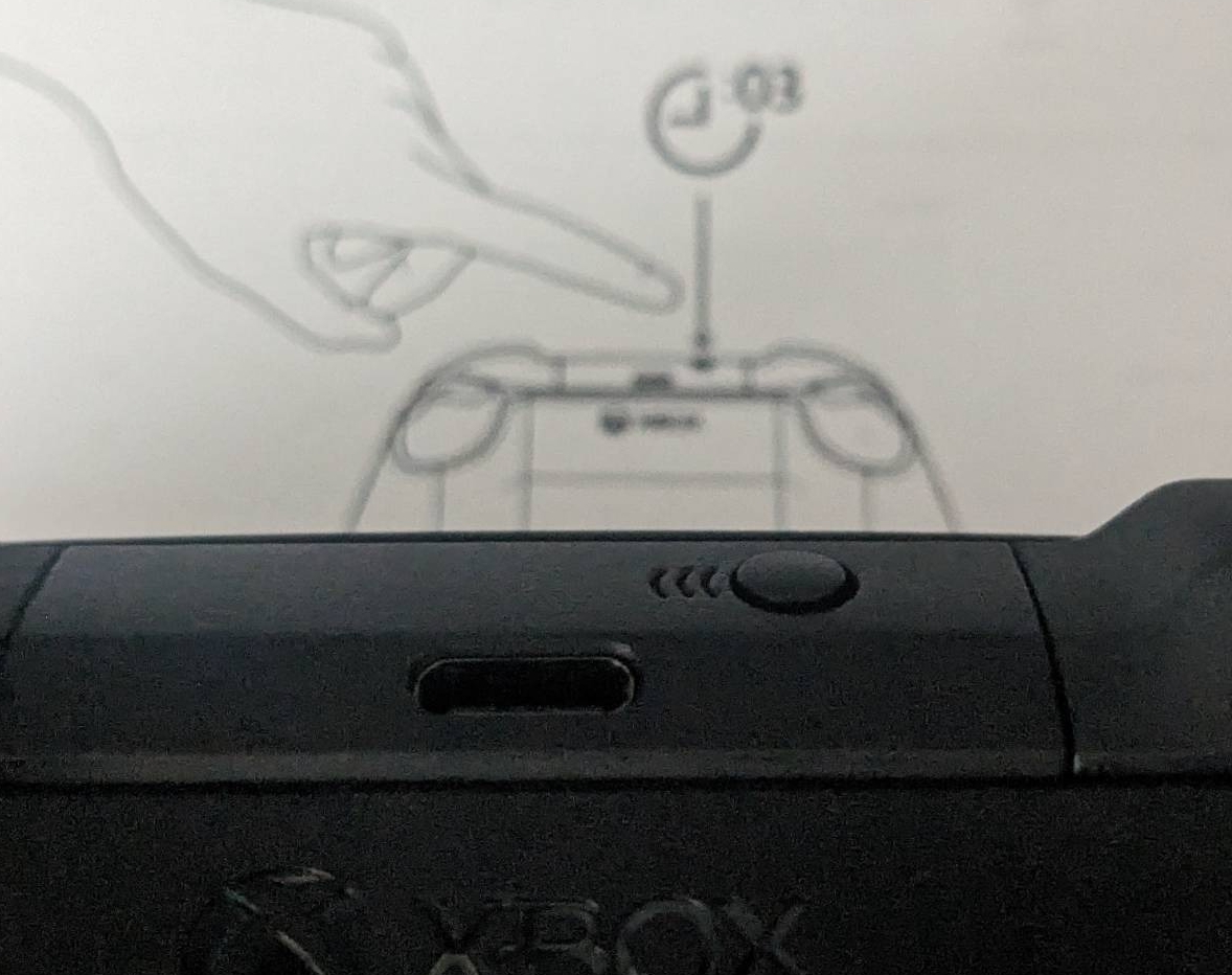Image shows the pair button on top of the controller